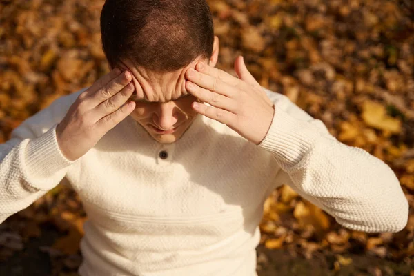 Man Pain Holding His Forehead Sitting Autumn Park — Stock Photo, Image