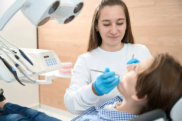 Boy Sits Dentist Chair Young Woman Doctor Puts Seal Him — Stock Photo, Image