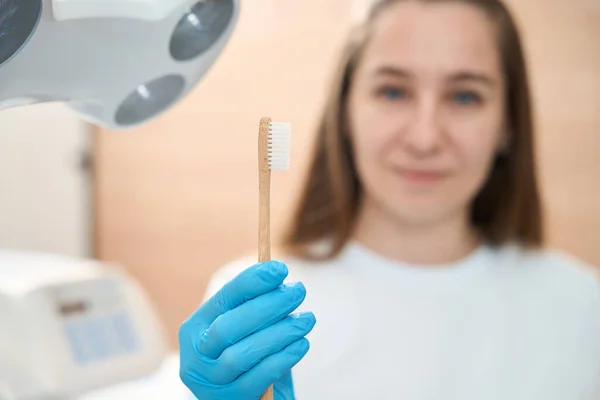 Woman Doctor Her Workplace Holds Toothbrush Her Hands She Uniform — Stock Photo, Image