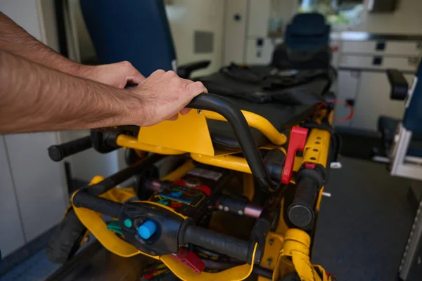 Male Activates Automated Gurney Patient Pulls Out Working Medical Transport — Stock Photo, Image