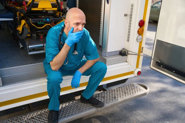 Sad Man Medical Uniform Sterile Gloves Sits Mobile Medical Equipment — Stock Photo, Image
