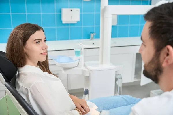 Calm Young Patient Sitting Dental Chair Listening Stomatologist Consultation — Stock Photo, Image