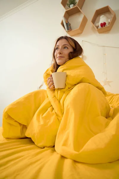 Dreamy Lady Wrapped Blanket Holding Mug Coffee Looking Ceiling — Fotografia de Stock
