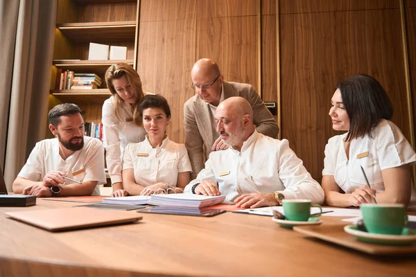 Team Doctors Seated Large Office Table Discussing Treatment Plan — Stock Fotó