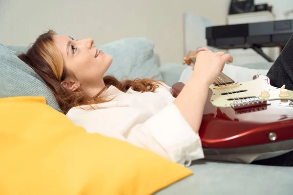 Smiling Happy Young Female Guitarist Lying Bed Playing Acoustic Guitar — Fotografia de Stock