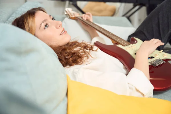 Calm Pensive Songwriter Strumming New Tune Stringed Instrument While Lying — Foto Stock