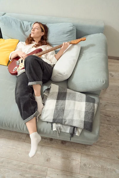 Dreamy Young Female Guitarist Playing Acoustic Guitar Bed Looking Distance — Fotografia de Stock