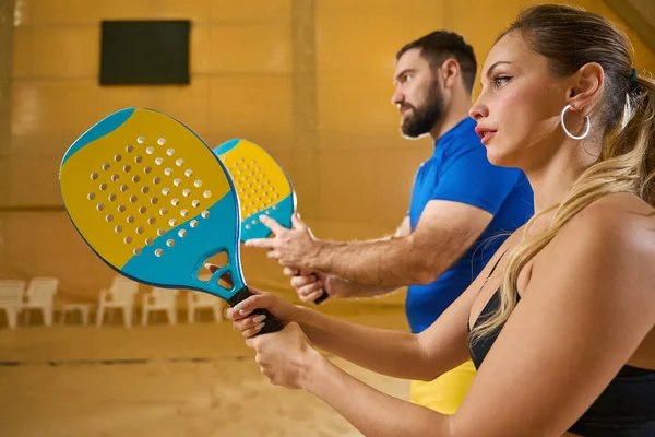 Focused Female Tennis Player Sportswear Looks Forward While Tall Partner — Zdjęcie stockowe