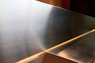 Shiny metal surface on the reception desk, modern materials used for the counter
