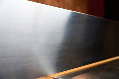 Metal decorative surface at the reception desk, modern materials used for the counter