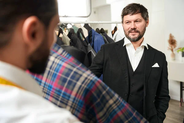 Fashion Designer Showing Pleased Customer Tartan Fabric Dummy His Workshop — Stock Photo, Image