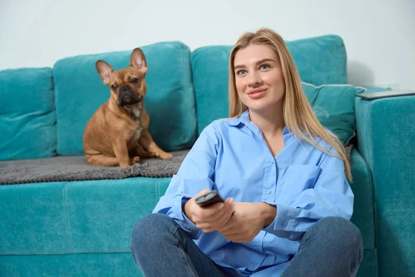 Pleased Young Female Changing Channels Presence Her Canine — Foto Stock