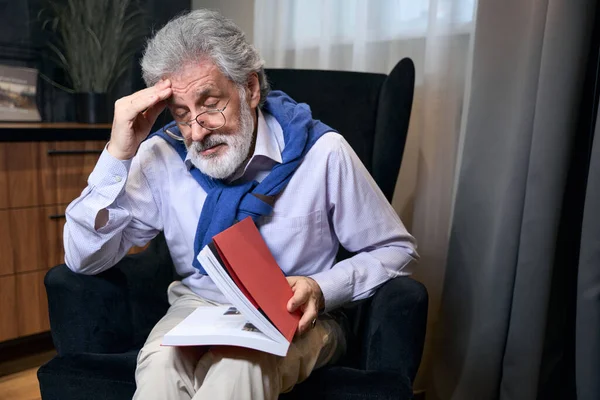 Bearded Old Male Sits Cozy Armchair Book Has Headache — Stock Photo, Image