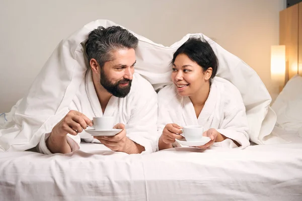 Romantique Jeune Couple Avec Des Tasses Dans Les Mains Couché — Photo