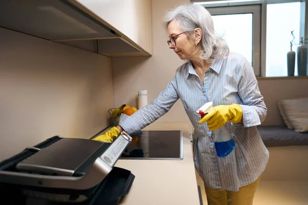 Nette Oudere Vrouw Wast Keuken Fornuis Met Een Zachte Doek — Stockfoto