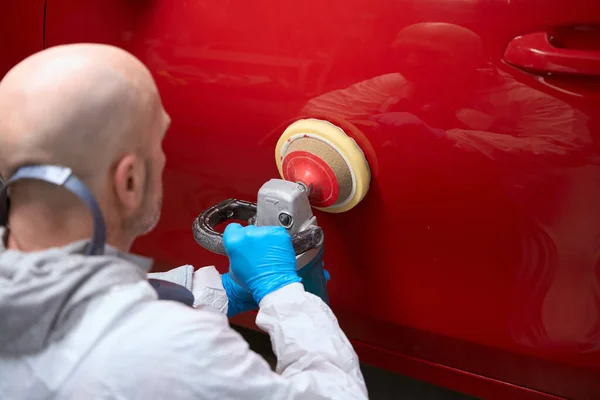 Man Repairs Body Red Car Grinds Area Straightening Painting — Stock Photo, Image