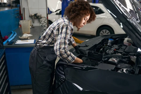 Ung Kvinna Arbete Overaller Kontrollerar Motorn Huven Bil Befälhavaren Arbetar — Stockfoto