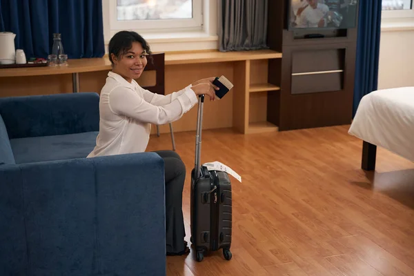 Pleased Female Tourist Trolley Suitcase Passport Sitting Sofa Hotel Room — Stock Photo, Image