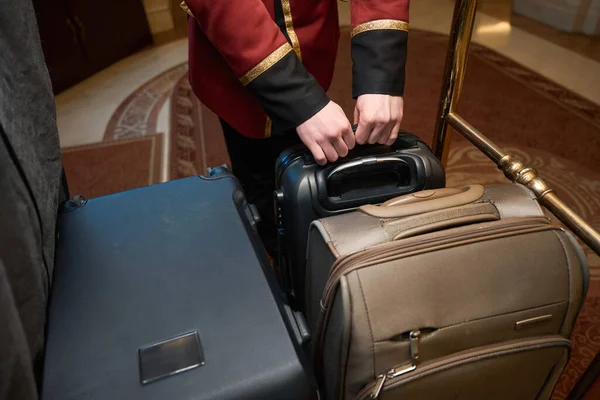 Bellboy Loading Large Travel Suitcases Trolley Guy Traditional Uniform — Stock Photo, Image