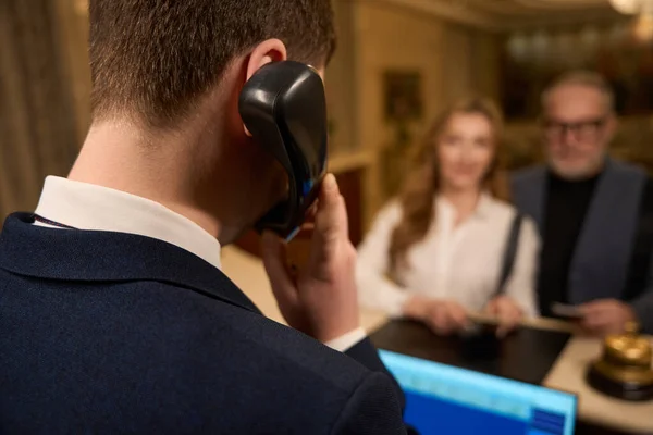 Receptionist Talking Phone Reception Desk Counter Travelers Passports Registering Hotel — Stock Photo, Image
