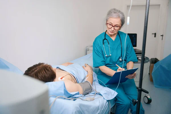Young Man Being Treated Cardiology Center Female Doctor Recording His — Stock Photo, Image