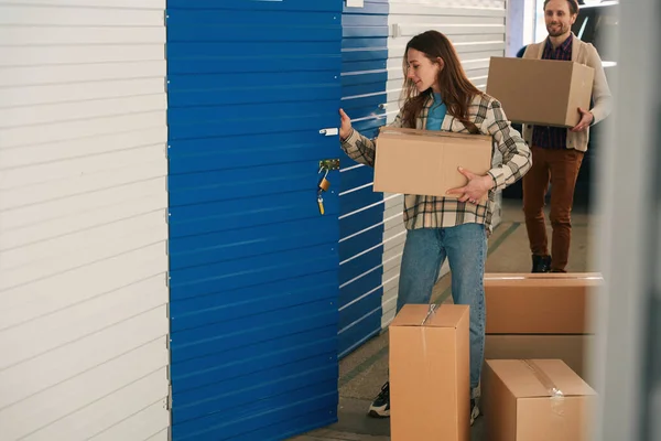 Lady Holding Large Box Opening Door Pantry Storage Warehouse Background — Stock Photo, Image