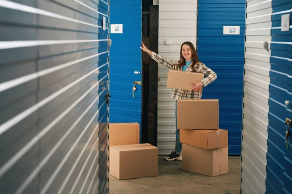 Smiling Lady Stacking Cardboard Boxes Things Storage Room Warehouse — Stock Photo, Image