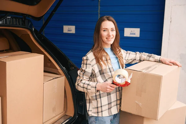 Smiling Lady Packing Cardboard Boxes Trunk Car Storage Warehouse — Stock Photo, Image