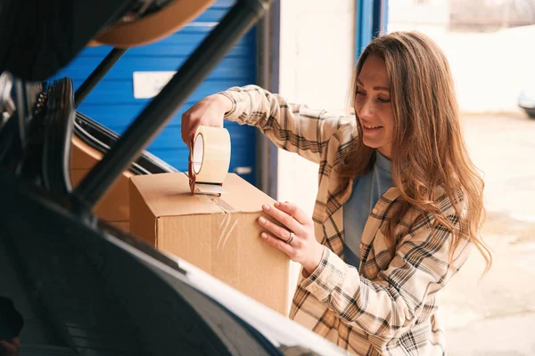 Smiling Lady Packing Cardboard Boxes Scotch Trunk Car Warehouse — Stock Photo, Image