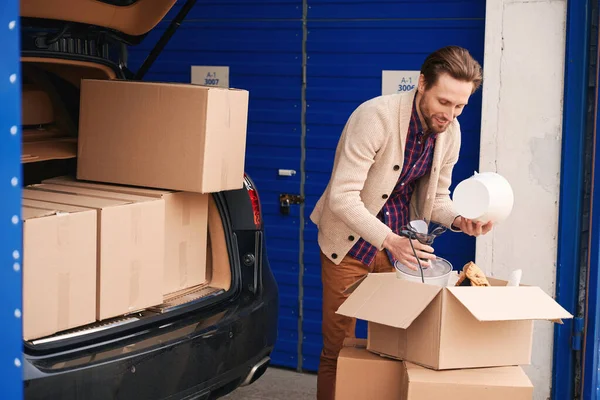 Guy Packing His Things Moving Cardboard Boxes Storage Warehouse Nearby — Stock Photo, Image