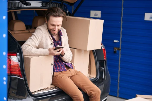 Happy Man Sitting Calling Trunk Car Storage Warehouse Cardboard Boxes — Stock Photo, Image