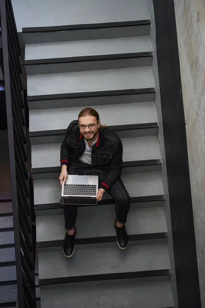 Вид Сверху Мужчину Фрилансера Ноутбука Который Смотрит Камеру Сидя Лестнице — стоковое фото