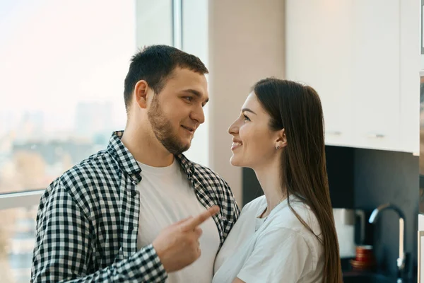 Smiling Young Spouses Standing Embracing View Window Kitchen Guys Casual — Stock Photo, Image