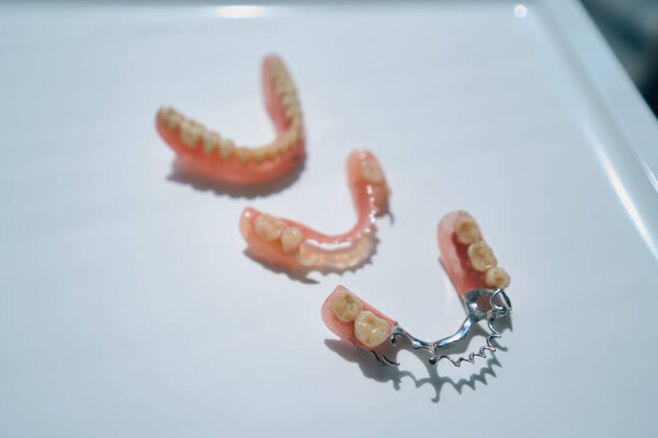 Modern dentures lie on the table, they are made of eco-friendly materials