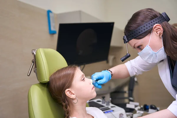 Doctor Otolaryngologist Examines Childs Nose Girl Sitting Special Green Chair — Stock Photo, Image