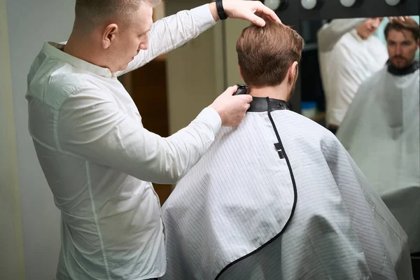 Handsome Man Looking Himself Mirror While Hairdresser Making Trendy Haircut — Stock Photo, Image