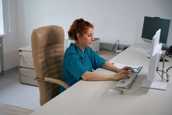 Concentrated Professional Medic Typing Computer Keyboard While Browsing Online Table — Stock Photo, Image