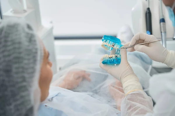 Orthodontist Toont Een Model Met Tandheelkundige Implantaten Aan Een Patiënt — Stockfoto