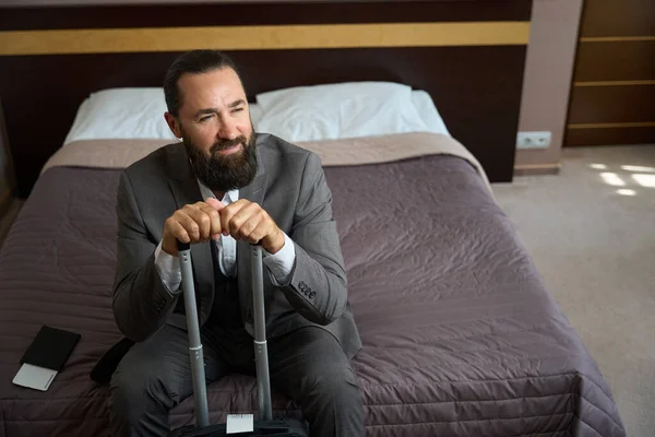 Bearded Middle Aged Man Sits Bed Hotel Bedroom Has Small — Stock Photo, Image