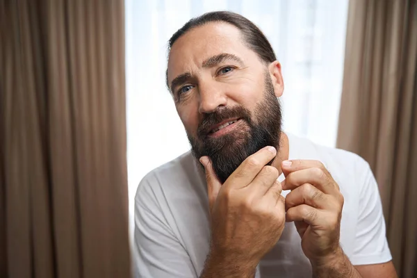 Middle Aged Male Examines His Thick Beard Man White Clothes — Stock Photo, Image