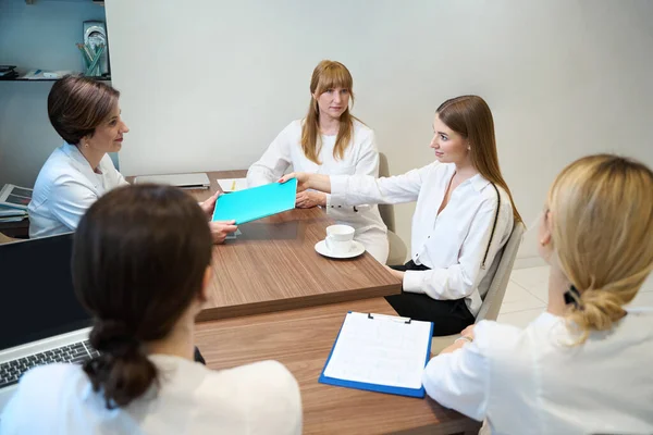 Woman Doctor Passes Folder Young Lady Medical Consultation Patient Taking — Stock Photo, Image