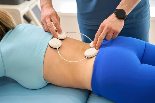 Male Rehabilitation Specialist Putting Sensors Female Spine Conducting Myostimulation Procedure — Stock Photo, Image