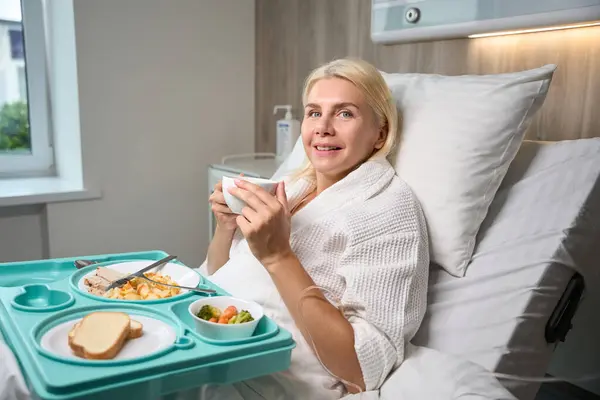 Krásná Žena Leží Nemocničním Lůžku Před Modrý Podnos Dietním Jídlem — Stock fotografie