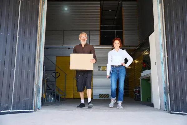Woman Blue Folder Man Walk Warehouse Man Has Cardboard Box — Stock Photo, Image