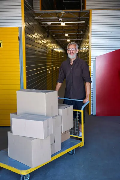 Gray Haired Man Carrying Lot Boxes Cargo Cart Warehouse — Stock Photo, Image