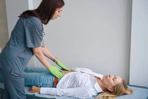 Focused General Practitioner Palpating Female Patient Abdomen Lying Supine Position — Stock Photo, Image