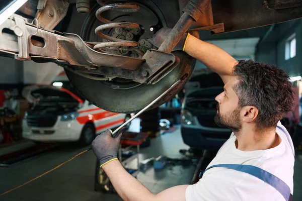Serious Focused Caucasian Automotive Service Technician Checking Motor Vehicle Suspension — Stock Photo, Image