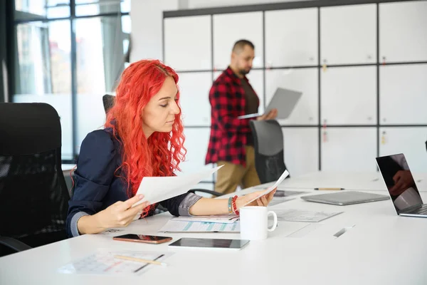 Serious Red Haired Woman Event Planner Sitting Office Looking Papers — Stock Photo, Image