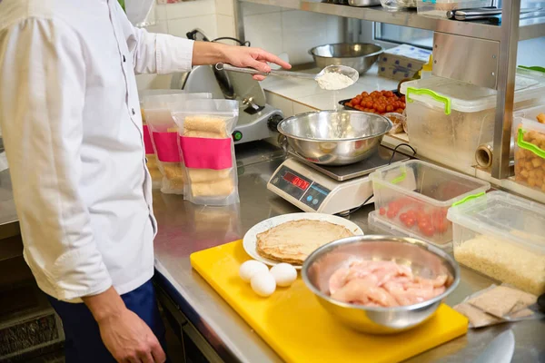 Kitchen staff prepares pancakes with special fillings, using high-quality products
