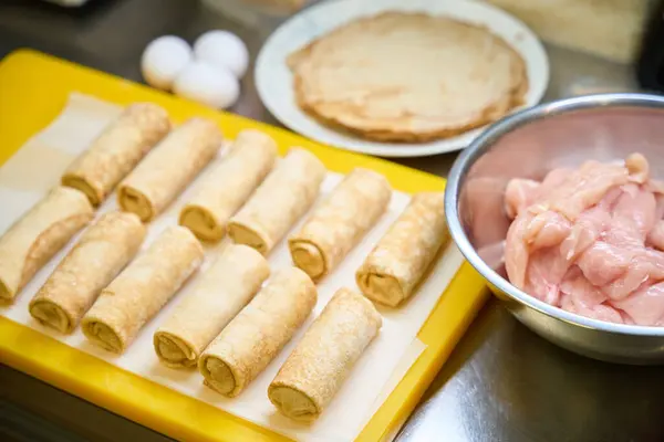 Pancakes with meat filling lie on the cutting board, fresh, high-quality products are used in the preparation